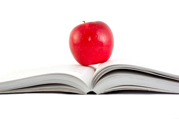 A red apple on a book on white backgrond