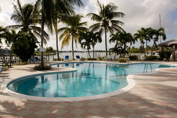 Fototapeta na wymiar marina swimming pool with blue sun beds and chairs