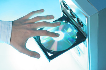 Inserting a CD-ROM into a personal computer 