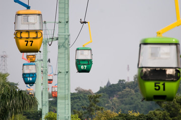 colorful cable car travelling inside a park © beltsazar