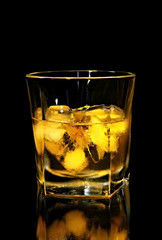 Scotch whisky on ice, with black background