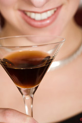 woman holding a cocktail glass, focus on the glass