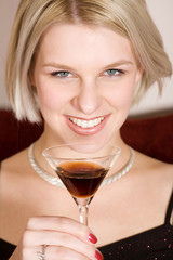 blonde woman holding a cocktail glass