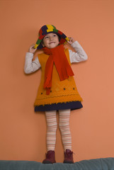 Little girl playing with bonnet