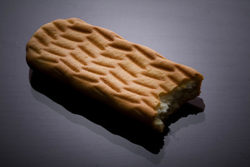 Cookie on plain background with Bite. Food concept