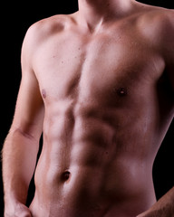 Fototapeta premium Torso mit Schweiss auf Waschbrettbauch