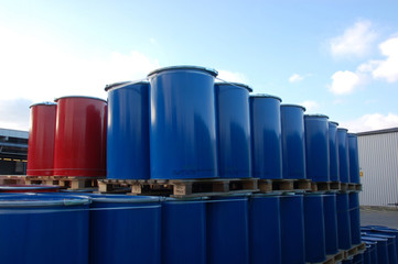 Red and blue oil barrels on an industrial site