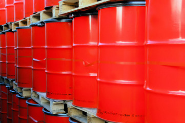 Assembly of red oil drums on palettes