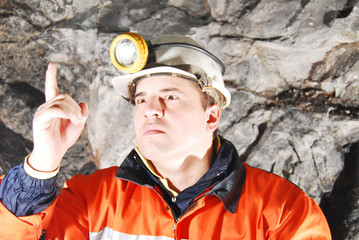 Angry chief miner in mine shaft criticizing stock photo