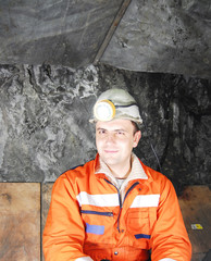 Portrait of a happy miner in a mine shaft stock photo