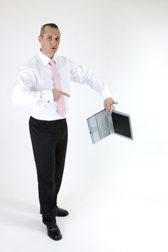 businessman breaks his laptop on white background