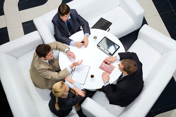 Businesspeople sitting around at the table 