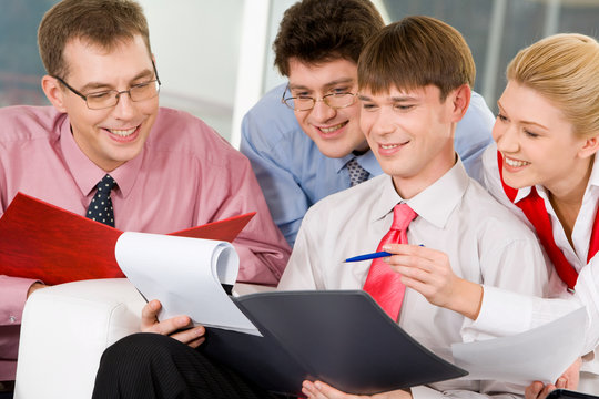 Team of four business people interacting 