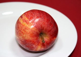 Apple on a white plate