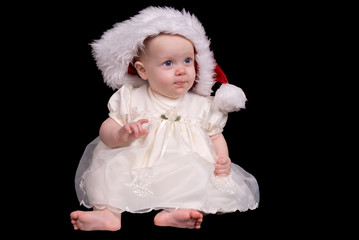 Baby girl with Santa hat in a white dress 