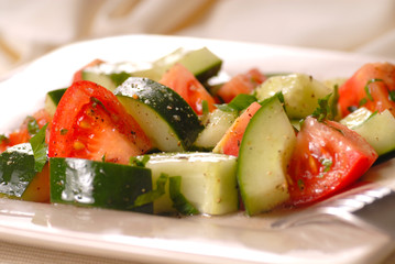 A tomato and cucumber salad with vinegrette