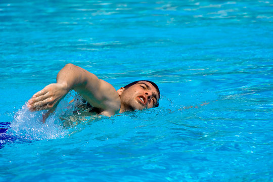 Man swimming in pool. Water sports concept