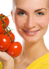 Beautiful girl with fresh tomatoes