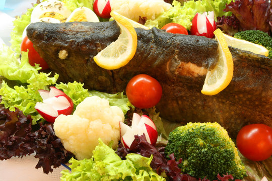 Exquisite restaurant cuisine - roasted trout in vegetable salad