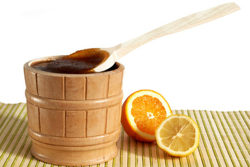 A pail with honey and slice of lemon