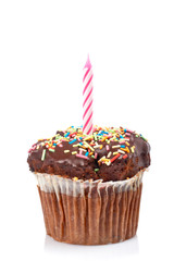 Muffin with candle isolated on white background. Shallow DOF