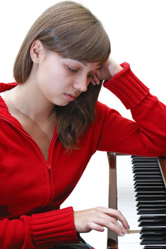 Beautiful Teen Girl Playing Piano On White Background Isolated