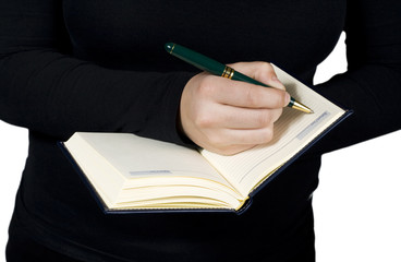 Close-up of a hand starting to write in a blank notebook