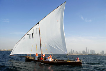 Arab Sailors On A Sailing Dhow And The Cityscape Of Dubai