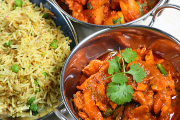 Close-up of indian chicken curry with pilau rice and Bombay aloo