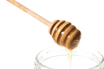 honey stick with jar isolated on white