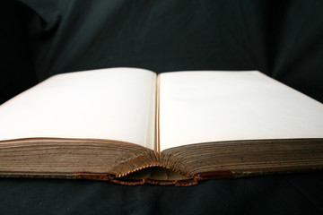 open rare old book on black fabric very Antique