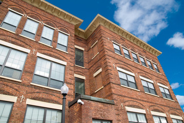 Urban Brick building with a blue sky and clouds