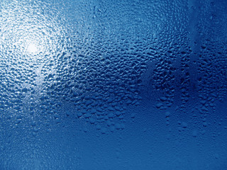 Close-up clear drops of water on window glass surface