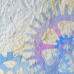 Blue cogwheel shapes overlaid onto textured paper