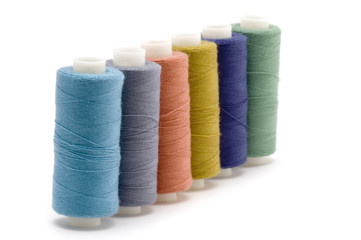 object on white: spool of thread