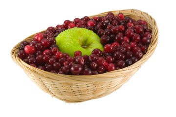red cranberries and apple in crib isolated on white background