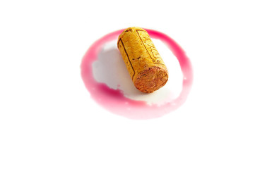 Red wine ring and cork on white
