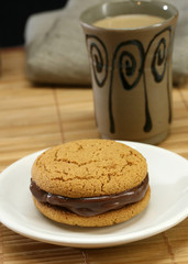 Fototapeta na wymiar A cup of coffee and a cookie