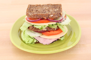 big sandwich on green plate on the table
