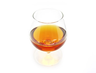 Glass of cognac on a white background