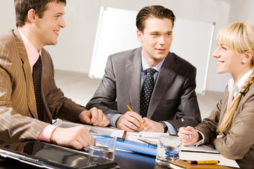 Business people discussing a working questions at meeting