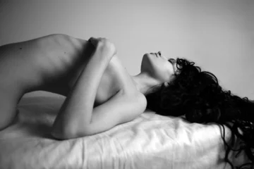Gordijnen Elegant nude girl with magnificent curly hair. Studio portrait. © Egor Mayer