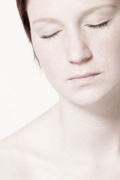 Studio Portrait Of A Young Woman With Short Hair Relaxing