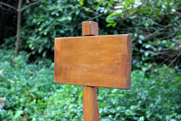 small wooden plaque against a green background