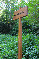 small wooden plaque against a green background