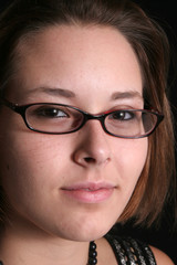 Woman in glasses with a smirk