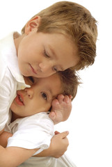 Two young little boys hugging each other; isolated on white