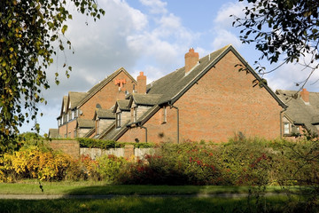 New bricks built housing estate seen through trees.