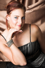 Young female adult fashion model with natural red hair 