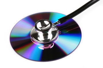 A stethoscope and a compact disk in white background.